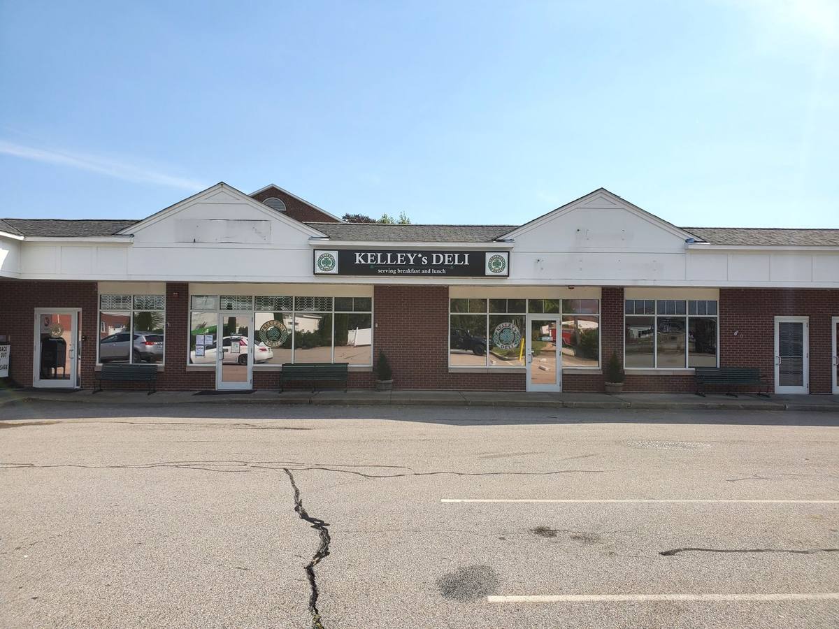Kelley's Deli storefront sign in a retail plaza