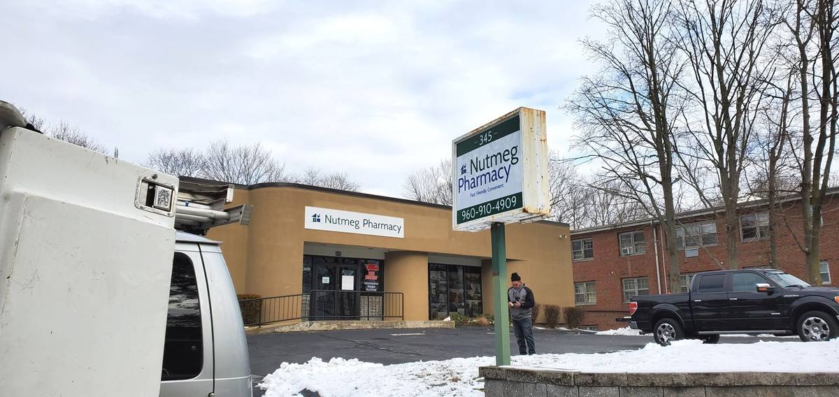 Nutmeg Pharmacy roadside pylon sign and storefront in New London