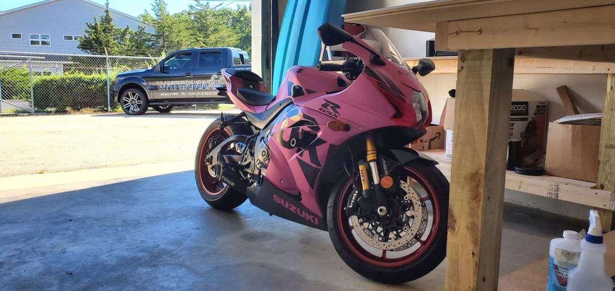 Suzuki sport bike after pink color change vinyl wrap with graphic accents